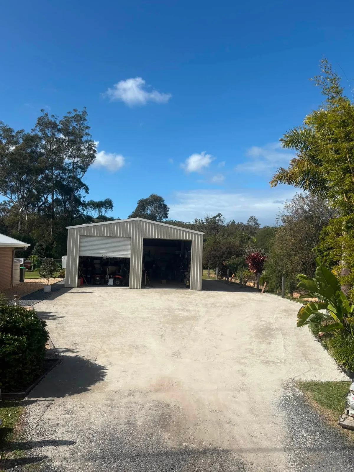 Completed white gravel driveway and hardstand in front of a rural shed