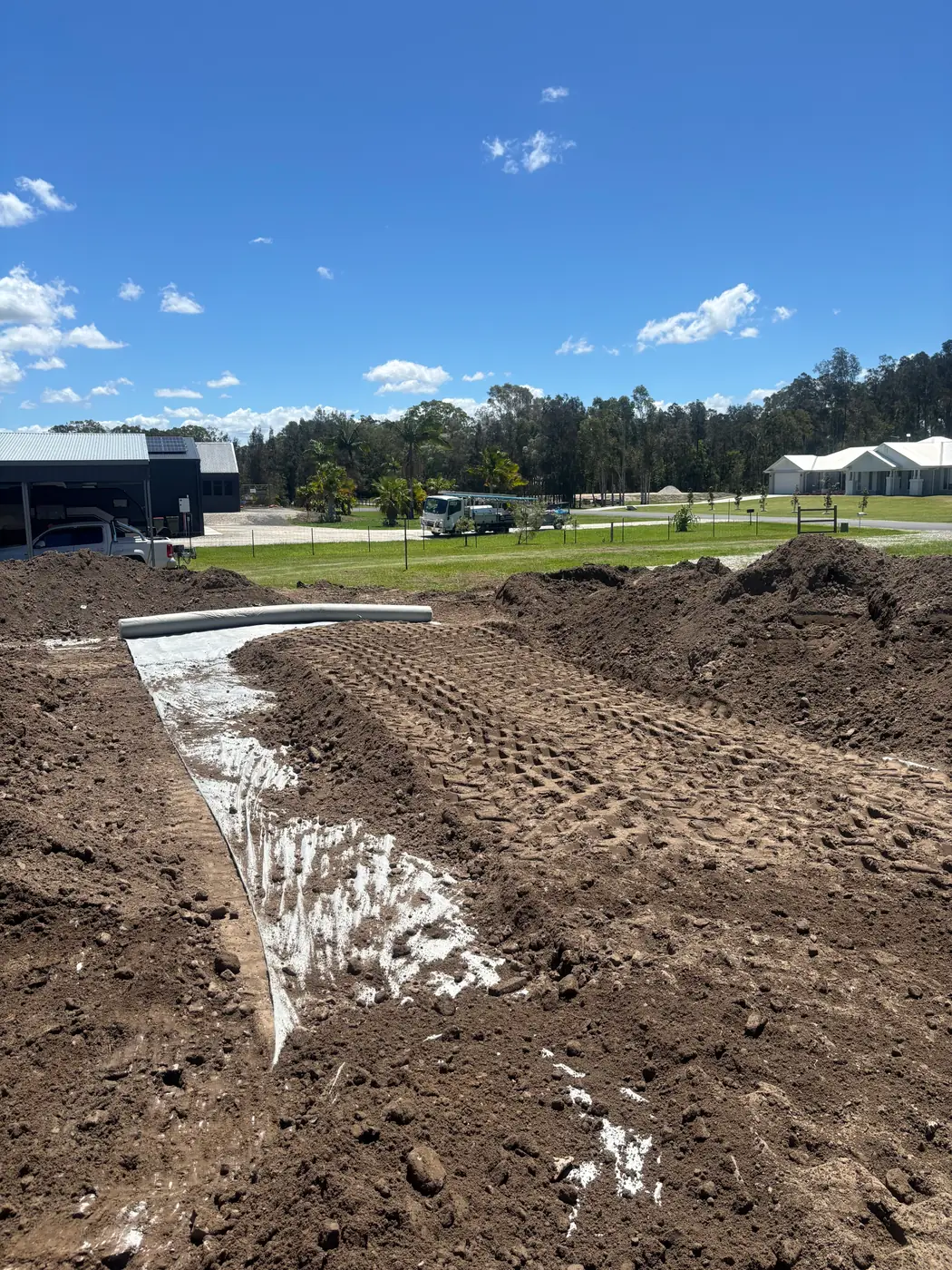 Geotextile fabric and fill along an earth embankment