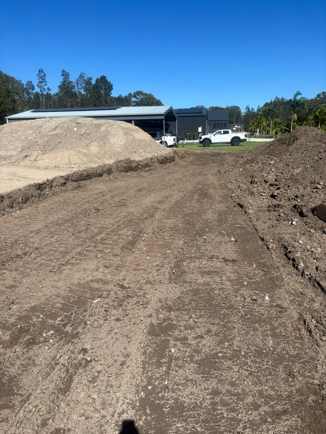 Bulk fill being placed and shaped for a residential flood mound