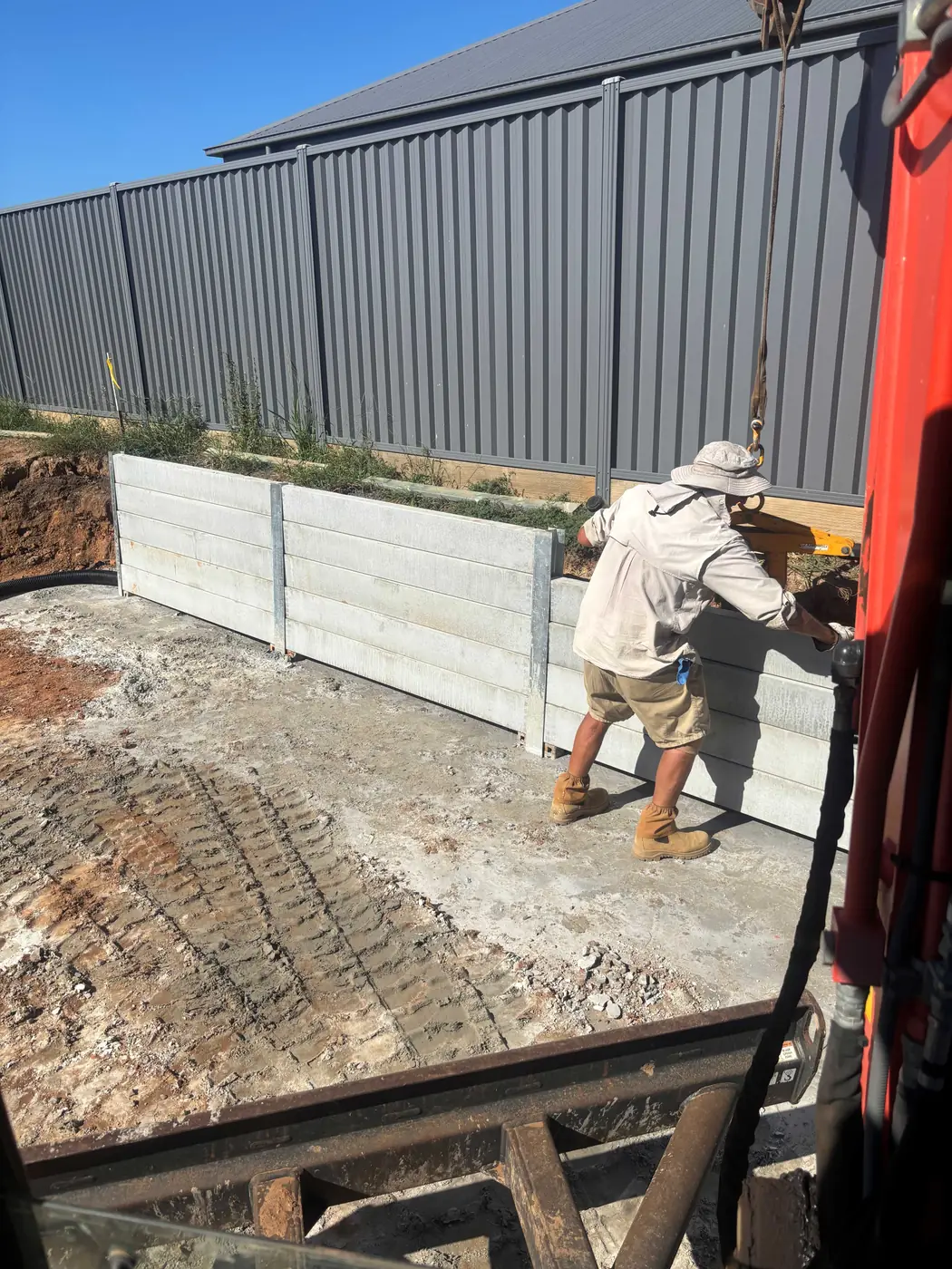 Concrete sleeper retaining wall under construction