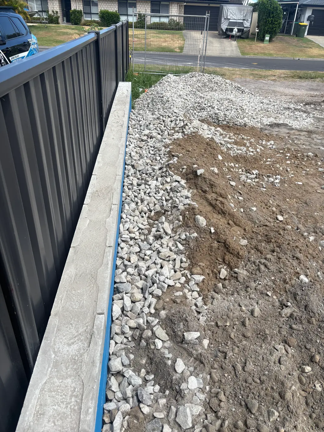 Drainage gravel placed behind a concrete sleeper retaining wall