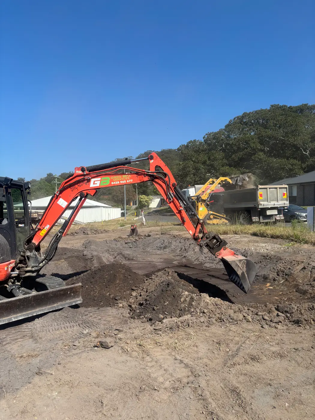 Excavators and tipper working a site cut
