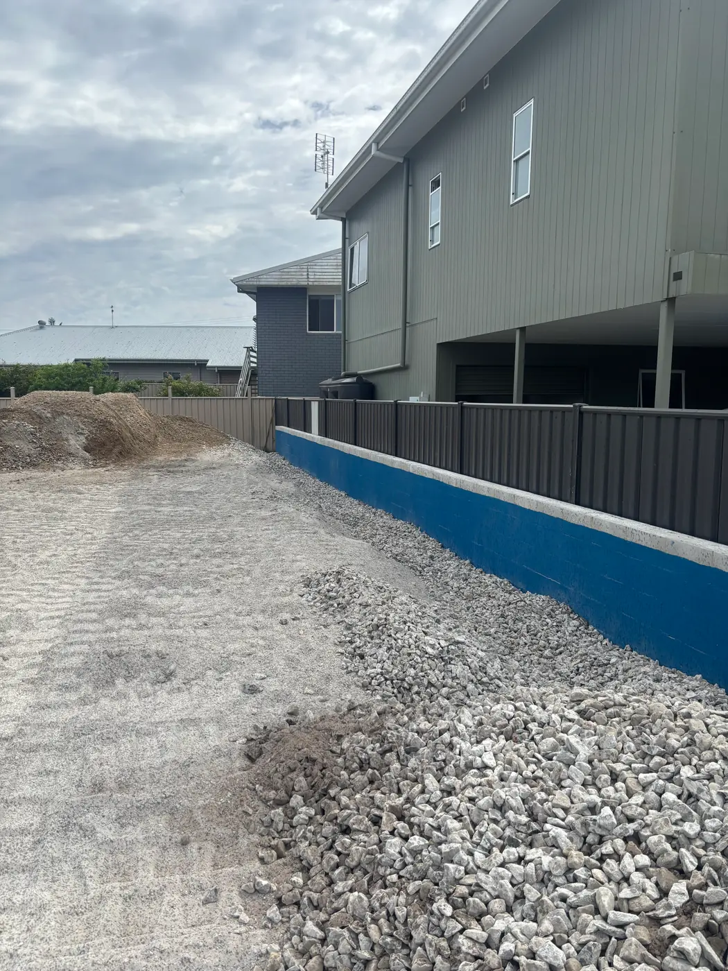 Drainage gravel delivered and placed behind a residential wall